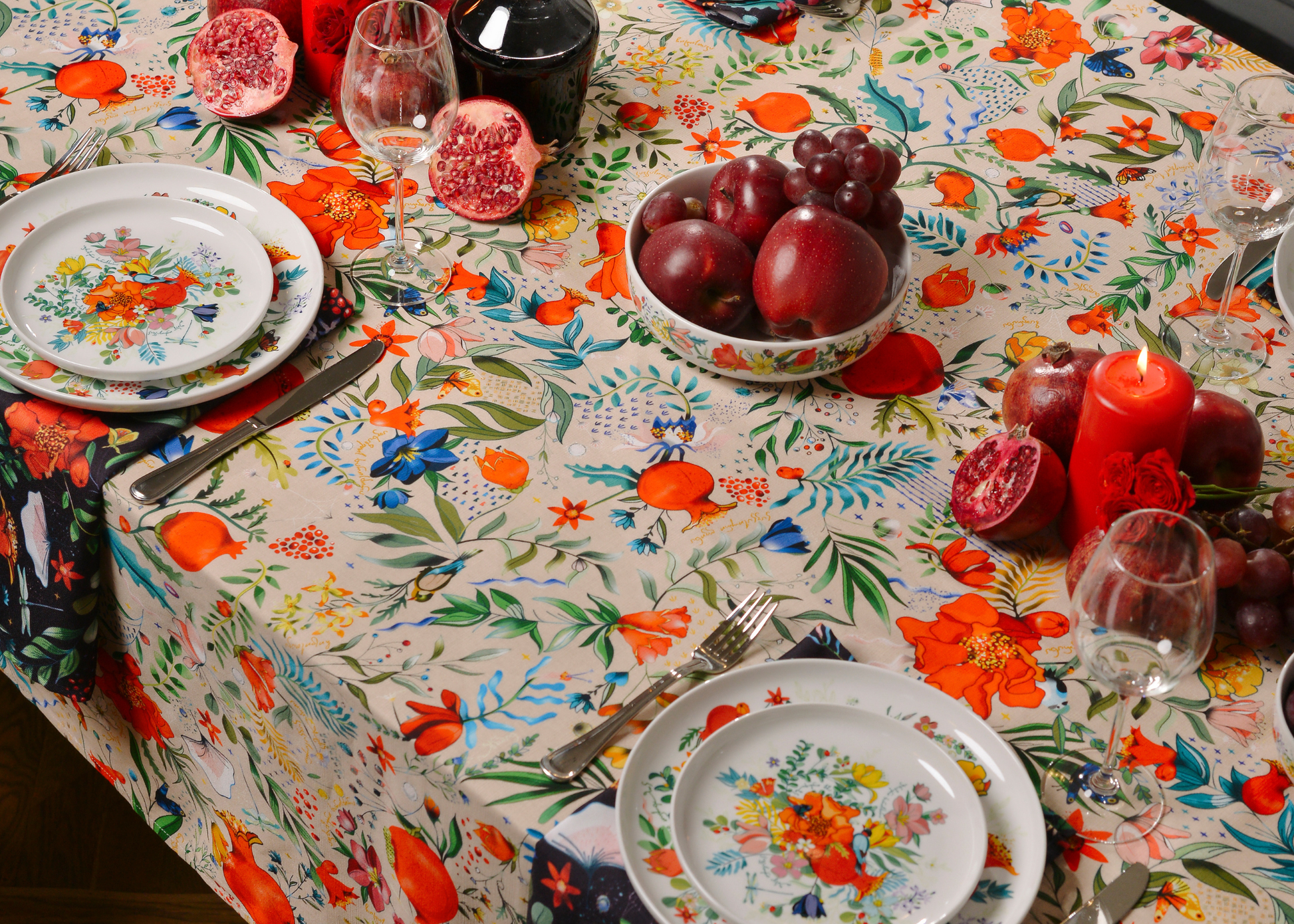 Light cream tablecloth with pomegranate and floral pattern laid flat