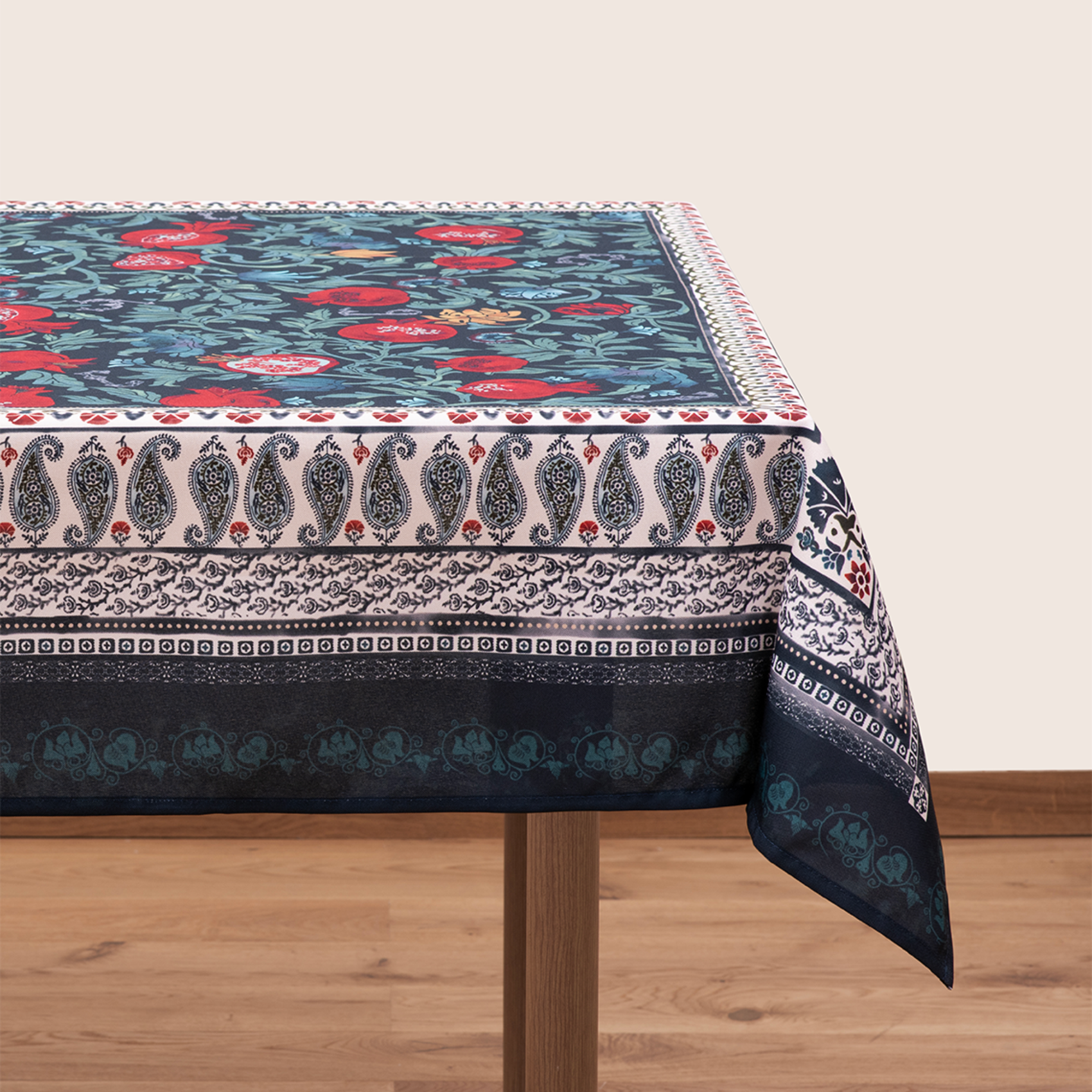 Blue tablecloth with alphabet script and pomegranate motifs on white background