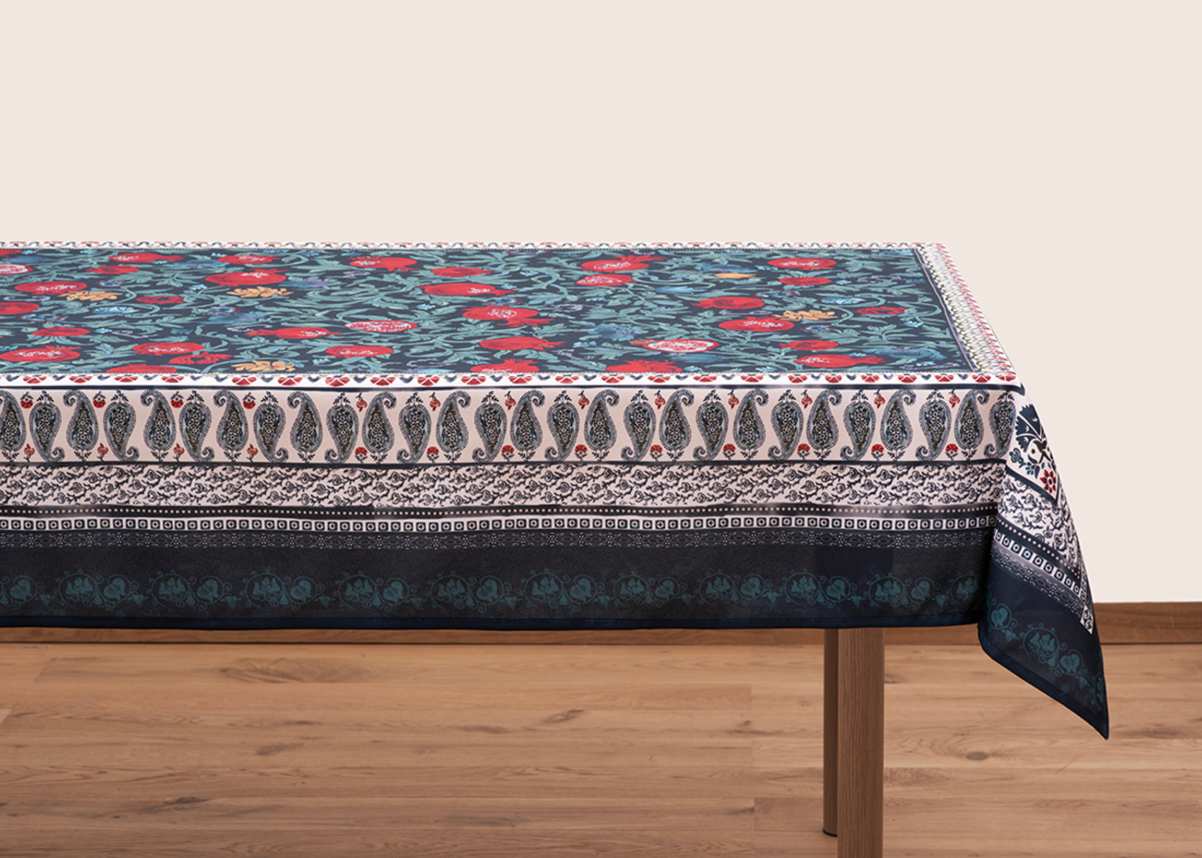 Blue tablecloth with alphabet script and pomegranate motifs on white background