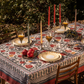 Red tablecloth with alphabet script and pomegranate motifs on white background