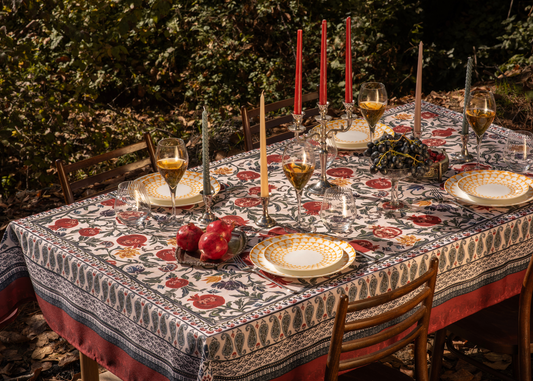 Red tablecloth with alphabet script and pomegranate motifs on white background