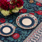 Detail of the BlueTabla Georgian Alphabet & Pomegranate tablecloth, showing the pomegranate-vine field and paisley border.