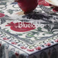Red tablecloth with alphabet script and pomegranate motifs on white background