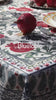 Red tablecloth with alphabet script and pomegranate motifs on white background